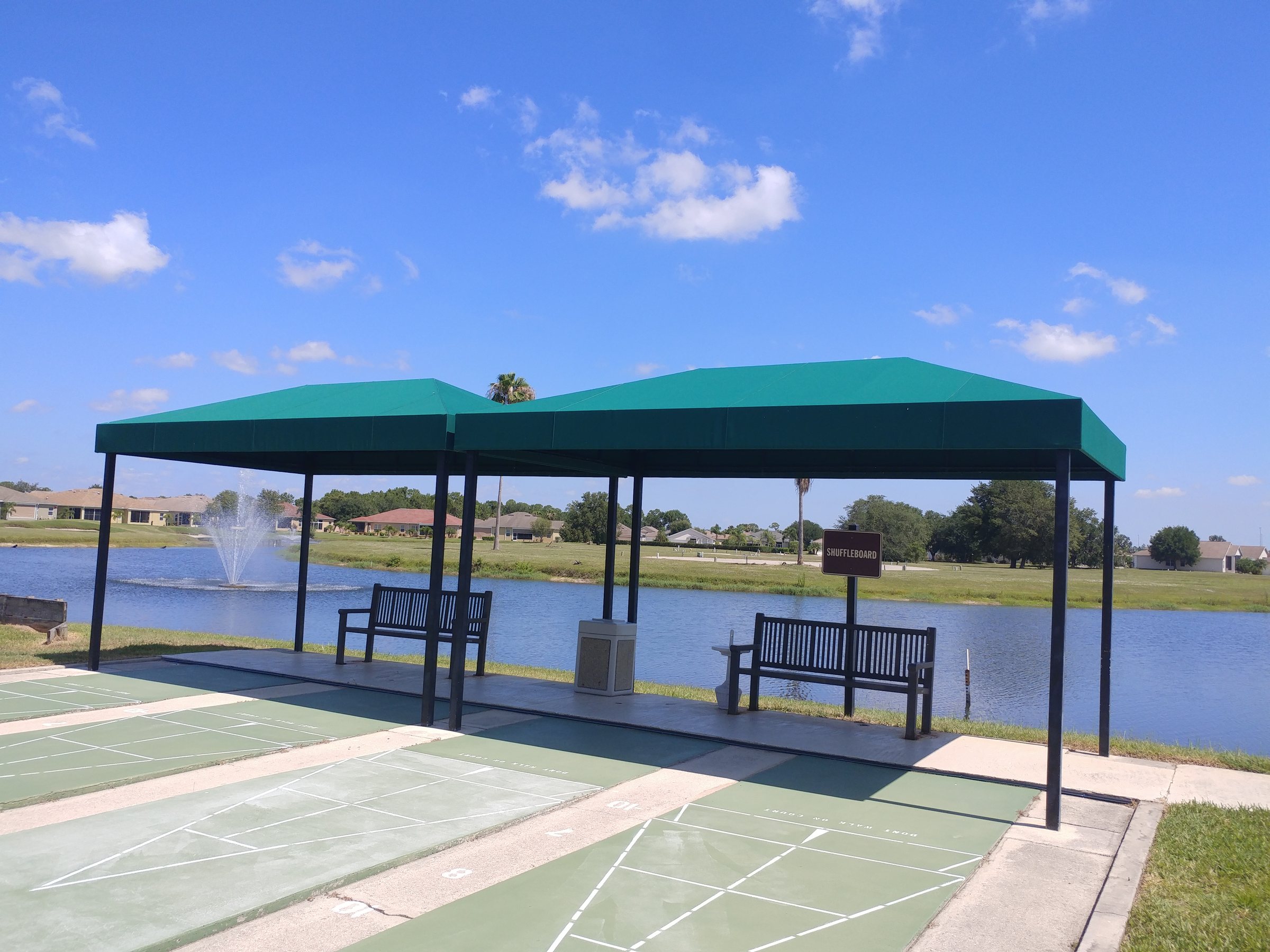 Freestanding aluminum canopy installed beside a lake