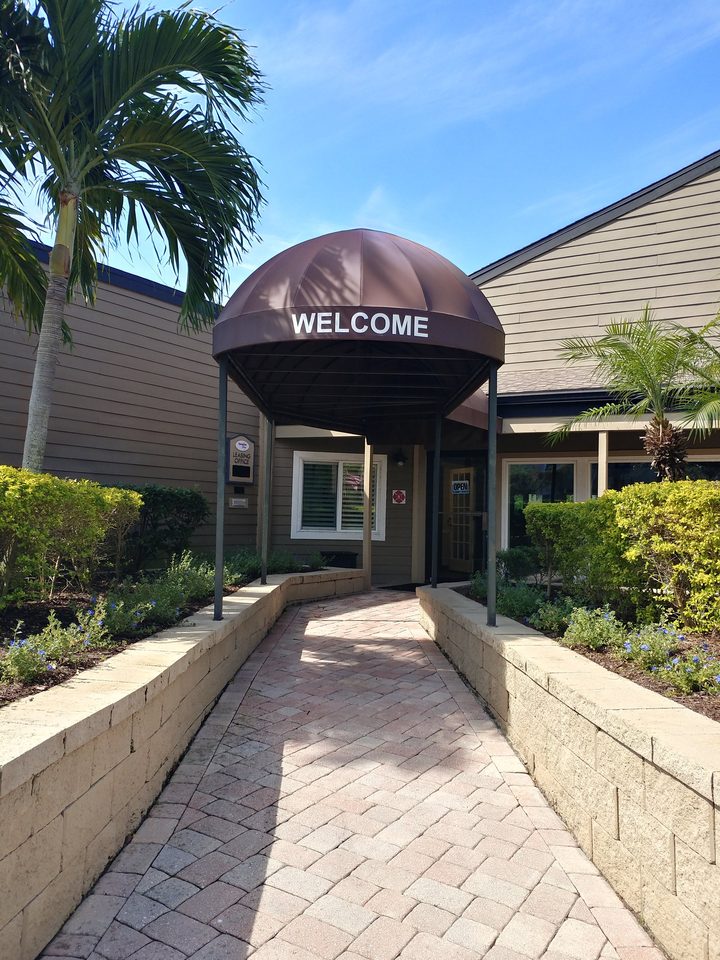 Brown fabric canopy over a commercial entrance walkway