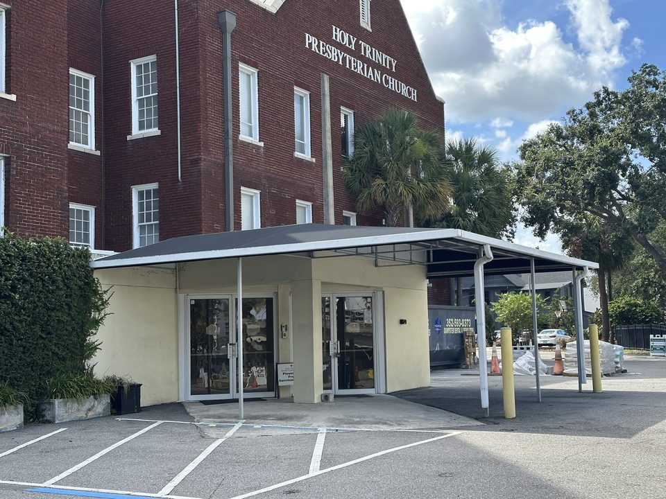 Long metal walkway canopy outside a commercial building