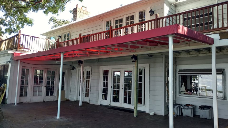 Red flat-panel patio cover attached to a home